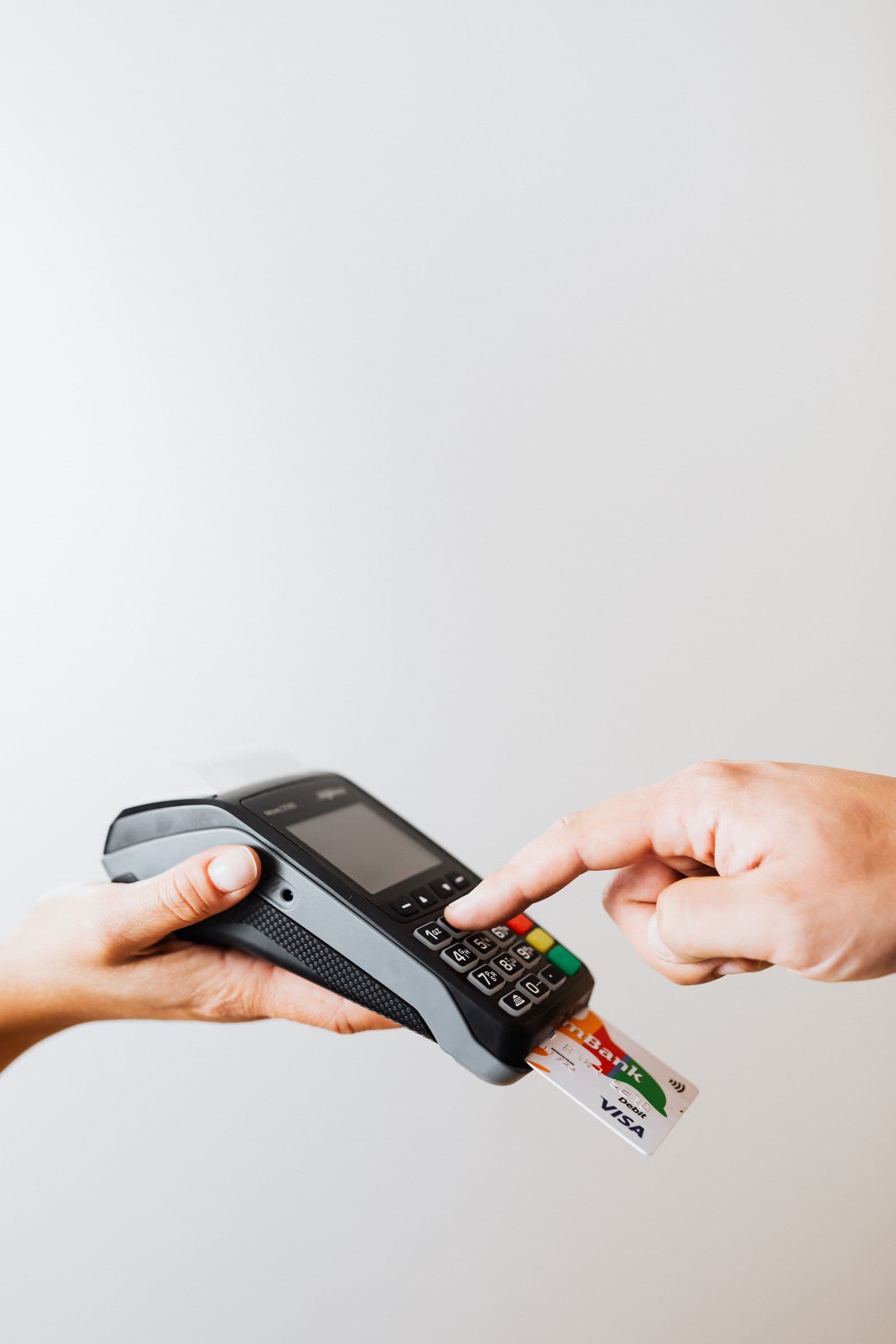 A contactless card being tapped at a payment terminal
